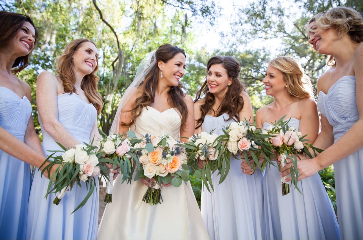 Wedding photography shot of bride & bridesmaids holding flowers